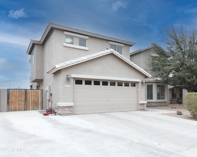 traditional home with a garage, stone siding, concrete driveway, and stucco siding