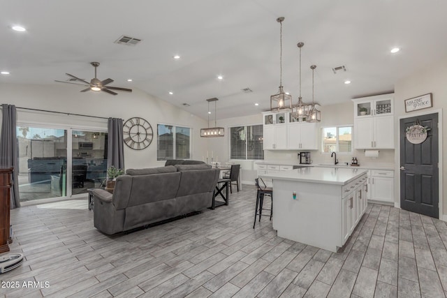 4446 W Kimberly Way, Glendale, AZ 85308 - kitchen with light countertops, open floor plan, a sink, a ceiling fan, and white cabinetry