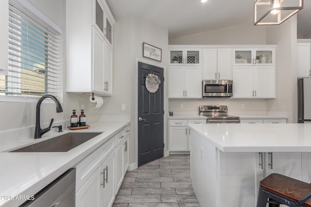 4446 W Kimberly Way, Glendale, AZ 85308 - kitchen with appliances with stainless steel finishes, a sink, lofted ceiling, white cabinetry, and light countertops