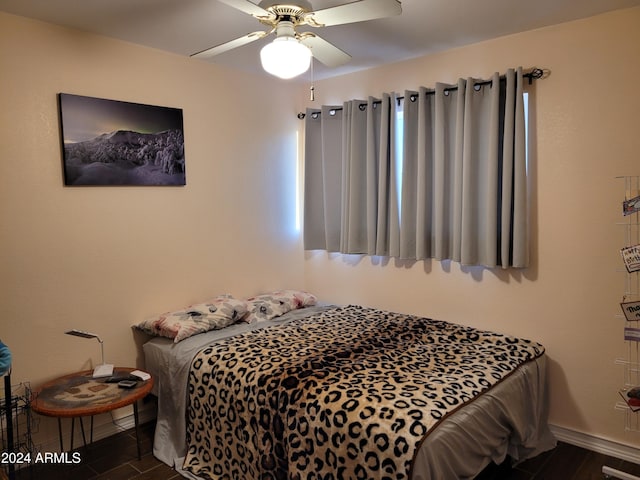 bedroom with ceiling fan and dark wood-type flooring