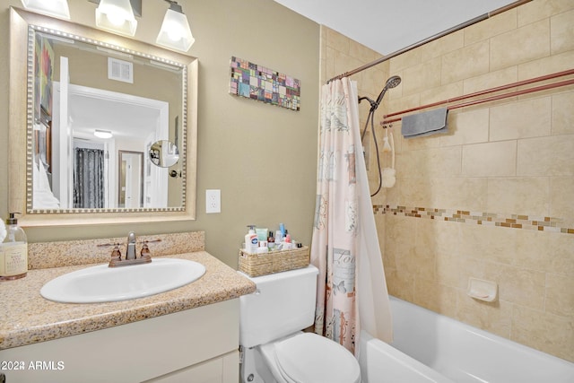 full bathroom featuring shower / tub combo, vanity, and toilet