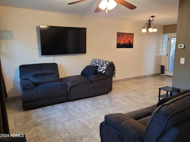 living room featuring ceiling fan with notable chandelier