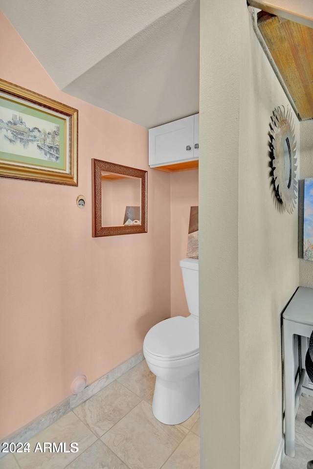 bathroom with tile patterned floors and toilet