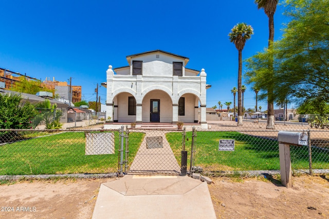 mediterranean / spanish-style home with a balcony and a front yard