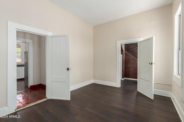 unfurnished bedroom with a closet and dark wood-type flooring