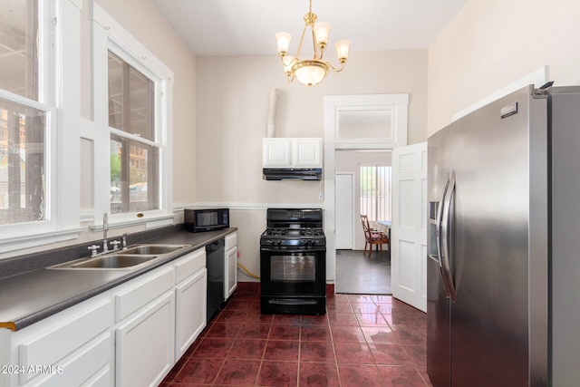 kitchen with white cabinetry, black appliances, dark tile patterned flooring, and plenty of natural light