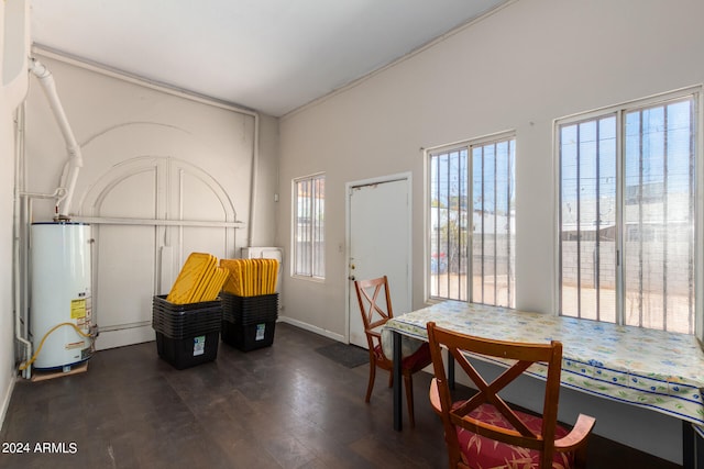 dining space featuring water heater and dark wood-type flooring