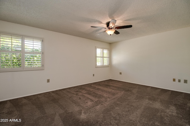 unfurnished room featuring dark colored carpet, a textured ceiling, ceiling fan, and baseboards