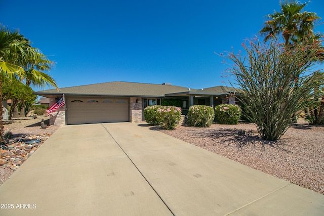 ranch-style house featuring concrete driveway and a garage