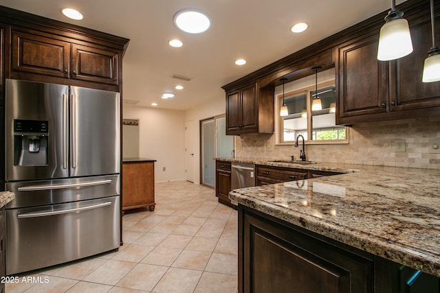kitchen with light tile patterned flooring, a sink, backsplash, and stainless steel appliances