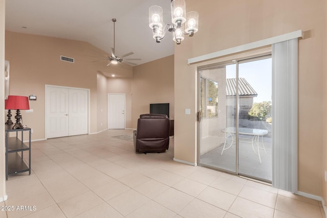 unfurnished room featuring light tile patterned flooring, lofted ceiling, and ceiling fan with notable chandelier