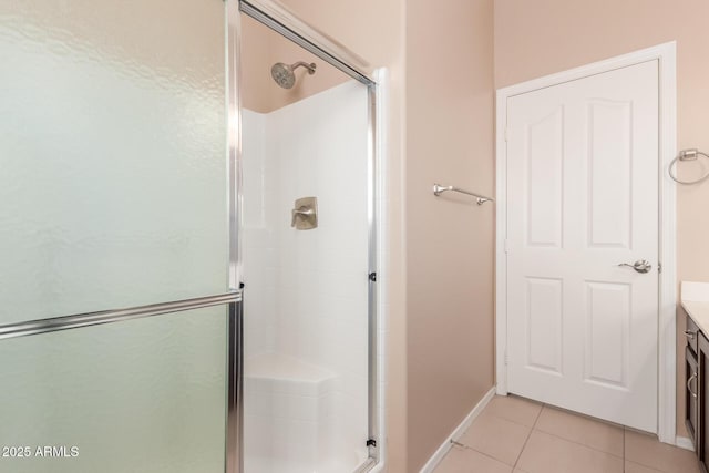 bathroom featuring vanity, tile patterned floors, and walk in shower