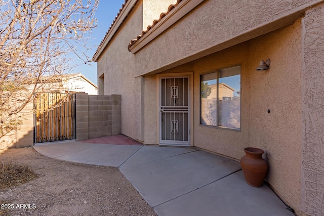 view of exterior entry featuring a patio area