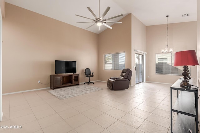 living room with ceiling fan with notable chandelier, high vaulted ceiling, and light tile patterned floors