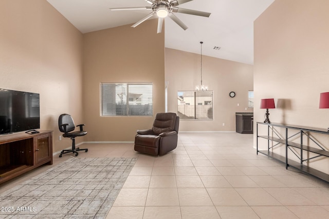 living area featuring light tile patterned flooring, high vaulted ceiling, and ceiling fan with notable chandelier