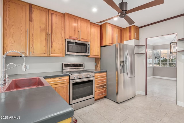 kitchen featuring ceiling fan, sink, stainless steel appliances, crown molding, and light tile patterned flooring