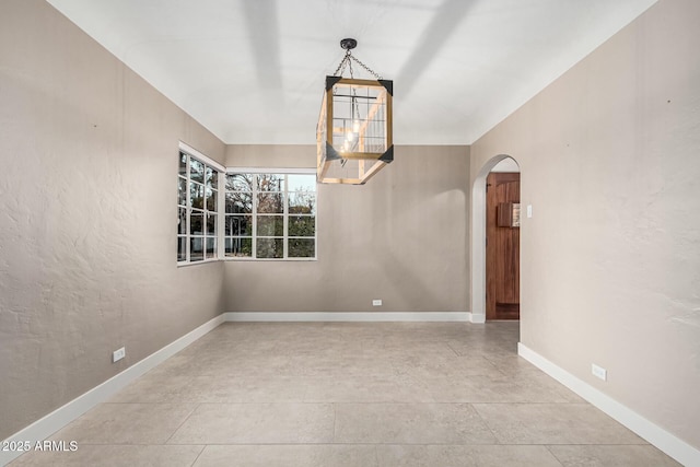 empty room featuring a chandelier