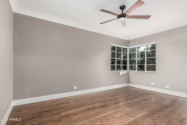 empty room featuring hardwood / wood-style floors and ceiling fan