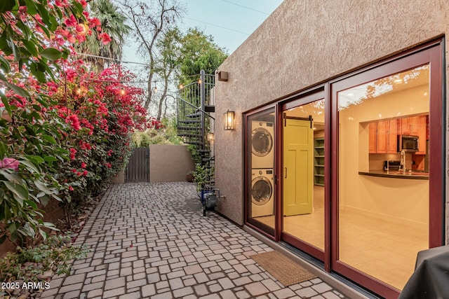 view of patio with stacked washer / drying machine