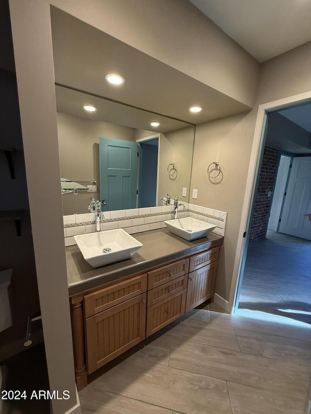 bathroom with vanity and backsplash