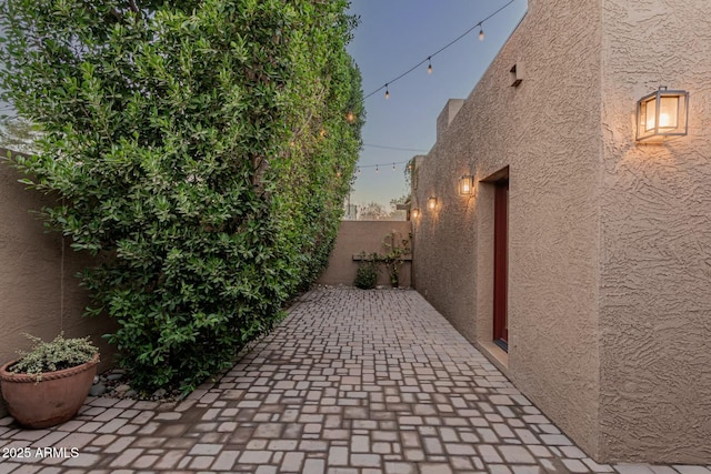 property exterior at dusk with a patio