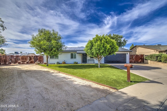 4162 W Sierra St, Phoenix, AZ 85029 - view of front of property with concrete driveway, roof mounted solar panels, a garage, and stucco siding