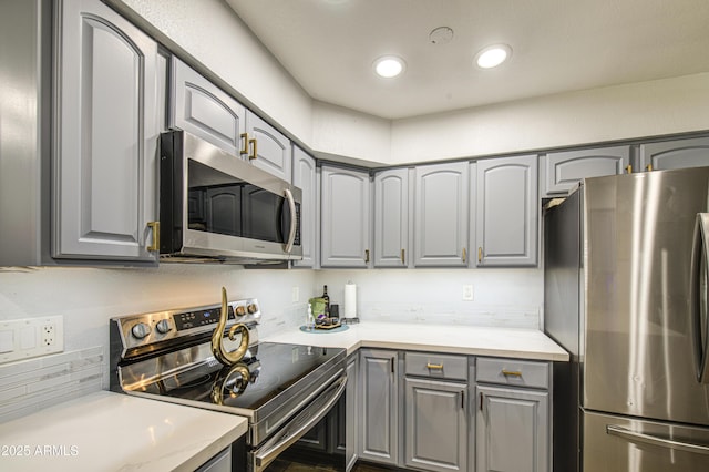 4162 W Sierra St, Phoenix, AZ 85029 - kitchen with appliances with stainless steel finishes, gray cabinets, light countertops, recessed lighting, and backsplash