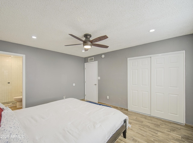 4162 W Sierra St, Phoenix, AZ 85029 - bedroom featuring light wood-type flooring, a closet, a textured ceiling, recessed lighting, and connected bathroom