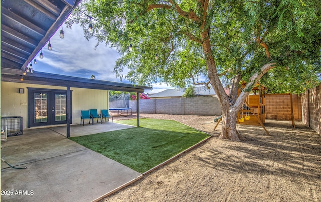 4162 W Sierra St, Phoenix, AZ 85029 - view of yard featuring a trampoline, french doors, a patio area, and a playground