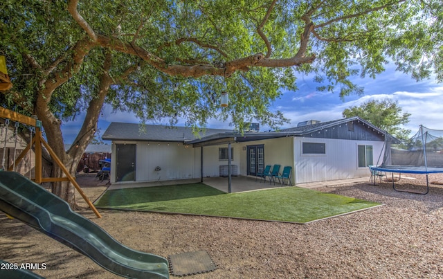4162 W Sierra St, Phoenix, AZ 85029 - rear view of house with a trampoline, a playground, a patio area, and a yard