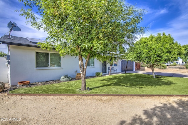 4162 W Sierra St, Phoenix, AZ 85029 - view of front facade featuring stucco siding, solar panels, and a front lawn