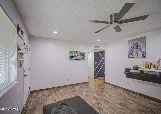 4162 W Sierra St, Phoenix, AZ 85029 - sitting room with wood finished floors, a ceiling fan, a textured ceiling, recessed lighting, and baseboards