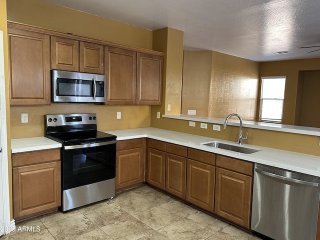 7511 S 45th Dr, Laveen, AZ 85339 - kitchen featuring visible vents, light countertops, brown cabinets, stainless steel appliances, and a sink