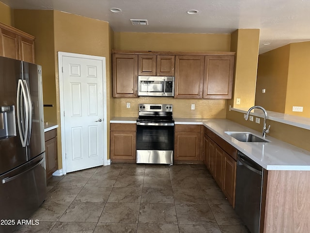 7511 S 45th Dr, Laveen, AZ 85339 - kitchen featuring visible vents, light countertops, a peninsula, stainless steel appliances, and a sink
