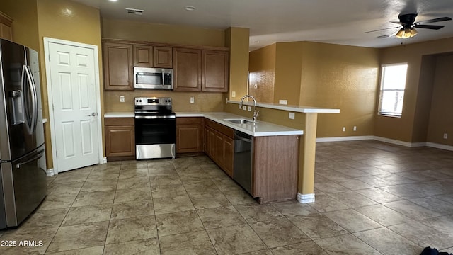 7511 S 45th Dr, Laveen, AZ 85339 - kitchen with visible vents, a ceiling fan, a sink, appliances with stainless steel finishes, and a peninsula