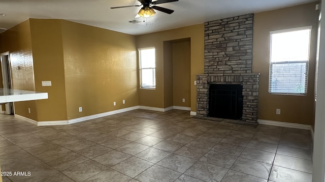 7511 S 45th Dr, Laveen, AZ 85339 - unfurnished living room featuring visible vents, ceiling fan, a fireplace, and tile patterned flooring