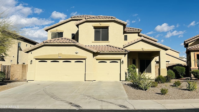 7511 S 45th Dr, Laveen, AZ 85339 - mediterranean / spanish house with stucco siding, driveway, fence, an attached garage, and a tiled roof
