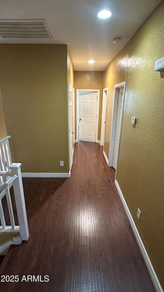 7511 S 45th Dr, Laveen, AZ 85339 - hallway with visible vents, baseboards, dark wood finished floors, and a textured wall
