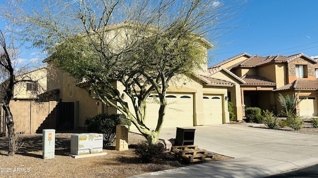 7511 S 45th Dr, Laveen, AZ 85339 - view of front of house featuring a tiled roof, a garage, driveway, and stucco siding