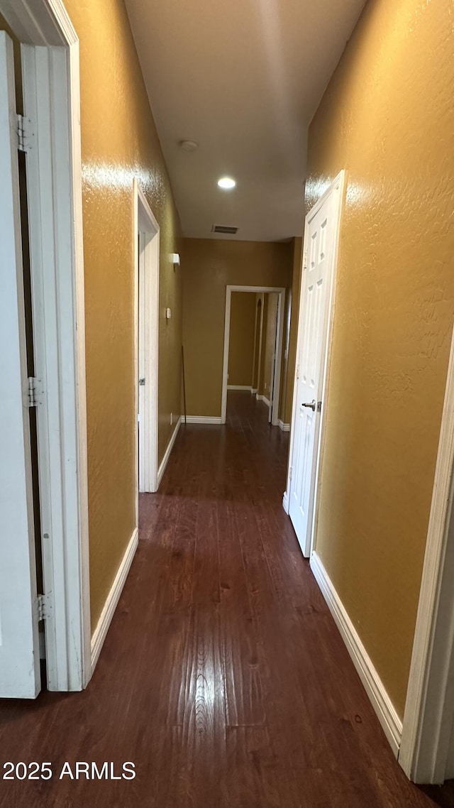 7511 S 45th Dr, Laveen, AZ 85339 - hallway featuring visible vents, a textured wall, and wood finished floors