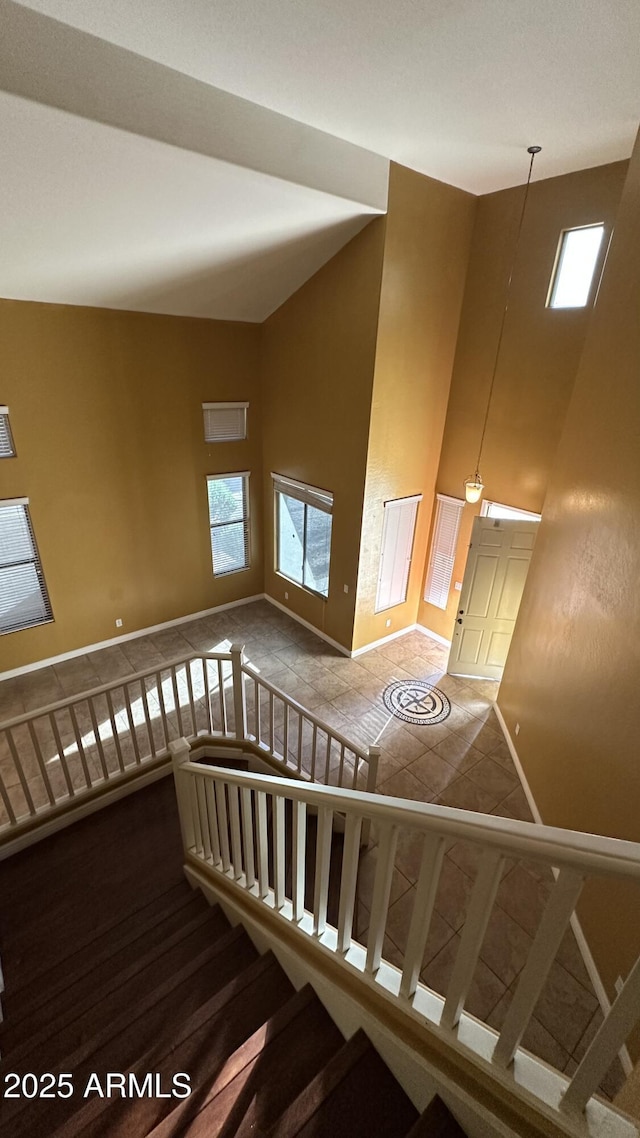 7511 S 45th Dr, Laveen, AZ 85339 - stairway featuring baseboards, plenty of natural light, and high vaulted ceiling