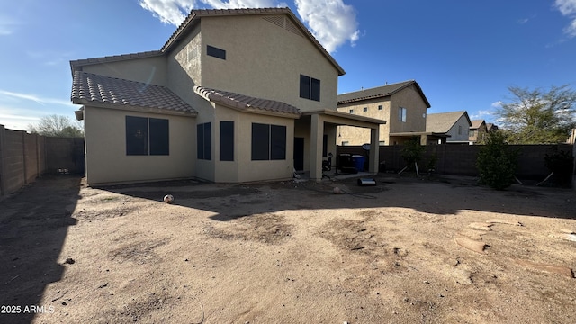 7511 S 45th Dr, Laveen, AZ 85339 - rear view of house featuring stucco siding, a patio area, a fenced backyard, and a tiled roof