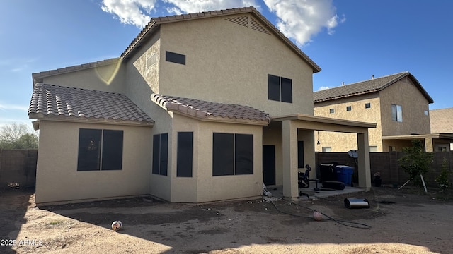 7511 S 45th Dr, Laveen, AZ 85339 - back of property featuring a tile roof, a patio area, fence, and stucco siding
