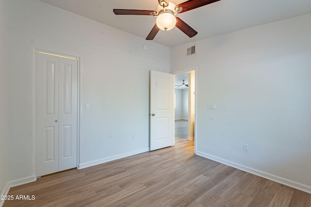 1219 E Colter St Unit 8, Phoenix, AZ 85014 - unfurnished bedroom featuring light wood-style flooring, a closet, and baseboards