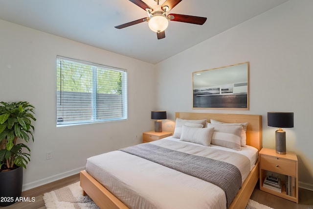 1219 E Colter St Unit 8, Phoenix, AZ 85014 - bedroom with wood finished floors, vaulted ceiling, baseboards, and ceiling fan