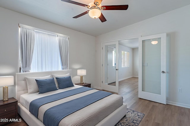 1219 E Colter St Unit 8, Phoenix, AZ 85014 - bedroom with vaulted ceiling, wood finished floors, baseboards, french doors, and a ceiling fan