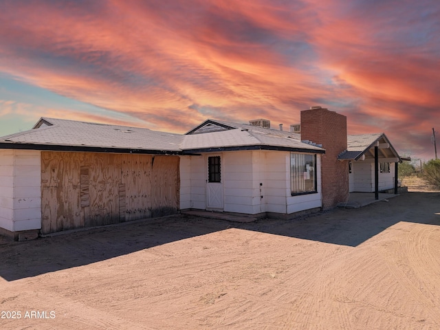 view of back house at dusk