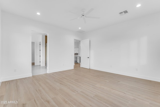 unfurnished room with ceiling fan and light wood-type flooring