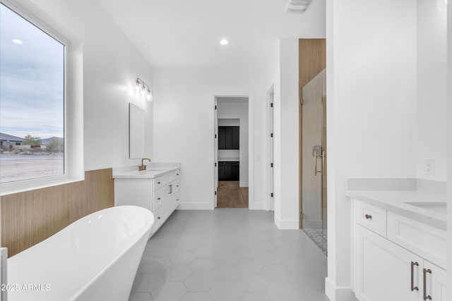 bathroom with vanity, plus walk in shower, and tile patterned flooring