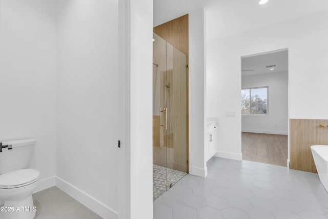 bathroom featuring walk in shower, vanity, toilet, and tile patterned flooring